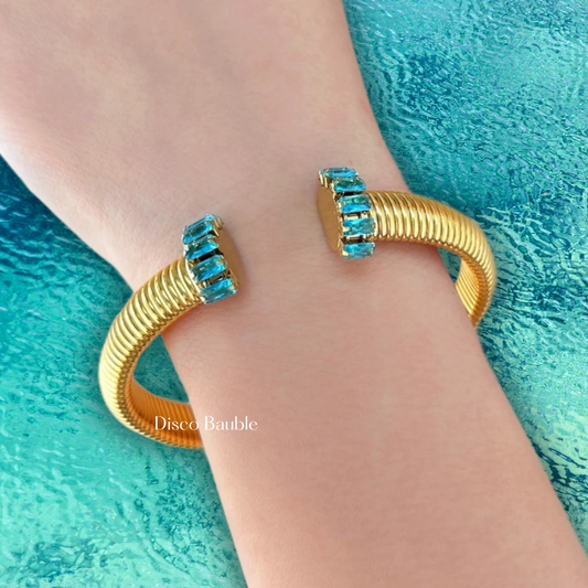 Gold plated bangle with blue stones